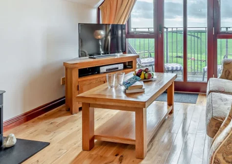 Countryside View, Crumplehorn is a romantic barn conversion perched on a peaceful hilltop outside Polperro, featuring a stunning balcony with sweeping countryside and distant views os the sea, cosy interiors and shared farm facilities.