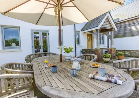The patio, barbecue & alfresco dining area at Court Barton Farm, South Huish