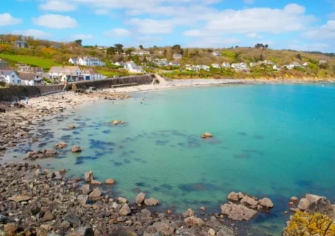 Coverack Beach, along the southern edge of the Lizard Peninsula, with a sandy arched beach is perfect for swimming & windsurfing