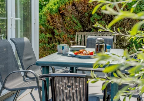 The patio & alfresco dining area at Cowries, Constantine Bay