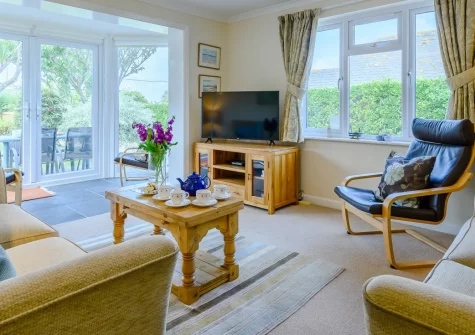 Cowries, Constantine Bay is a spacious five-bedroom coastal home just 400 metres from the golden sands of Constantine Bay, featuring two living areas, a sun-trap garden with terrace, and easy access to Padstow's harbour and restaurants.