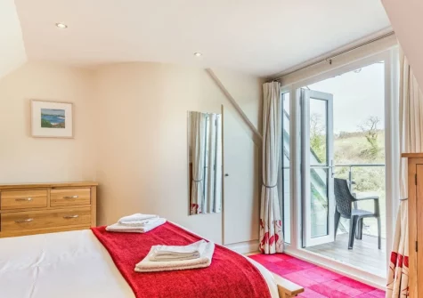 Bedroom #1, with balcony & outdoor sitting area,