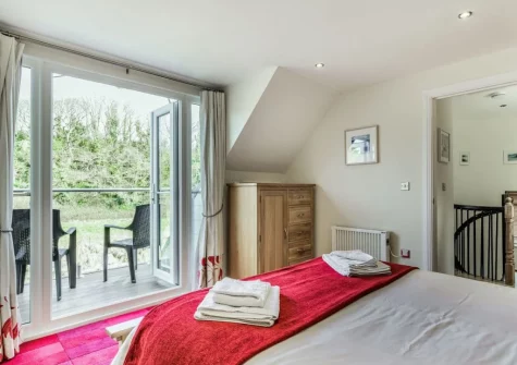 Bedroom #1, with balcony & outdoor sitting area,