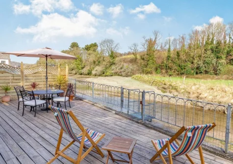 The decked terrace, barbecue, alfresco dining & outdoor sitting area at Creekside, Little Petherick
