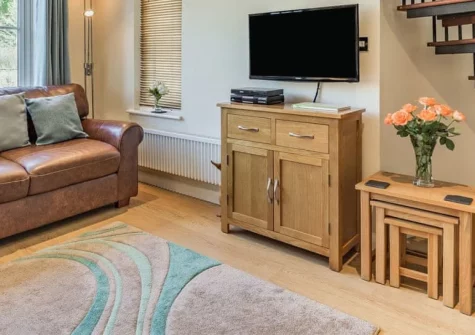 Creekside, Little Petherick is a peaceful two-bedroom cottage tucked away in a wooded valley beside a tidal creek, featuring a large private deck with direct creek access, cosy interiors, and footpaths leading straight to Padstow.