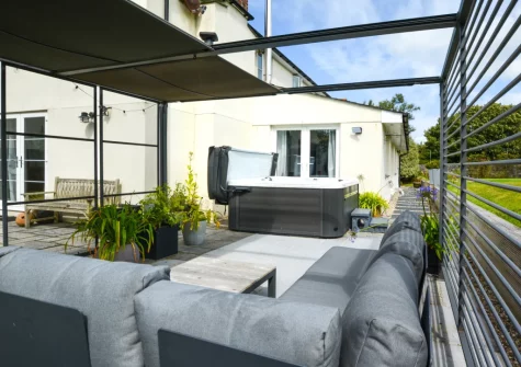 The patio, hot tub & outdoor sitting area at Croft House, Mitchell