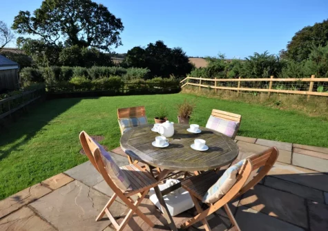 The patio, alfresco dining area & lawned garden at Curlew, Cotmore