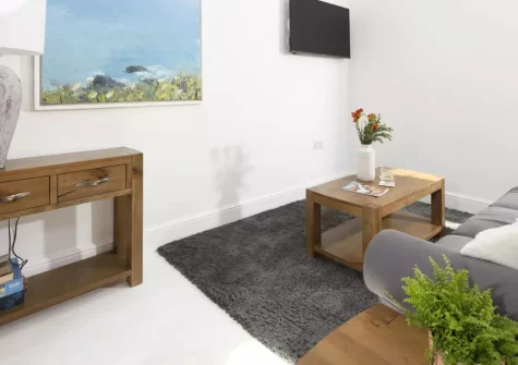 Cuthberts Barn, Crowlas is a stylish two-bedroom barn conversion near Penzance, featuring exposed granite walls, a sunny courtyard garden, dog-friendly comfort, and easy access to St Michael's Mount and Cornwall's finest coastal beaches.