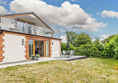 The decked patio, alfresco dining area & garden at Deer Lodge, High Bickington