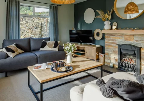 Dene Court, Trenance is a spacious, pet-friendly four-bedroom family house perched above Mawgan Porth, offering sea glimpses, a terrace for al fresco dining, a fire pit and garden, just half a mile from the dog-friendly surfing beach, shops and pub.