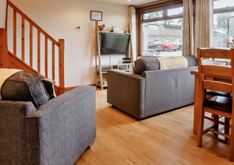 Dexter Barn, Launceston is a beautifully converted detached barn in peaceful countryside, featuring two double bedrooms with balcony, open-plan living spaces, private gardens with barbecue, and shared play area with trampoline for families.