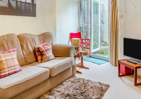Dingley Cottage, Porkellis is a charming stone cottage in peaceful West Cornwall, featuring a sheltered patio garden, welcoming interiors, and easy access to the dramatic Lizard Peninsula coastline, characterful harbour towns, and walks.
