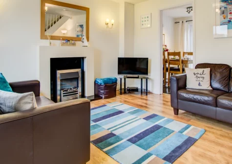 Dory Cottage, Padstow is a charming two-bedroom terraced retreat offering countryside views, a private enclosed garden with patio and BBQ, and parking, just a mile from Padstow's harbour, shops, restaurants and the scenic Camel Trail cycle path.
