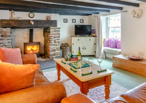 Drum Cottage, Appledore, is a characterful 17th-century two-bedroom retreat with original beams, a cosy wood burner, sun-filled conservatory, and enclosed garden. It's an ideal base for exploring North Devon's stunning coast and countryside.