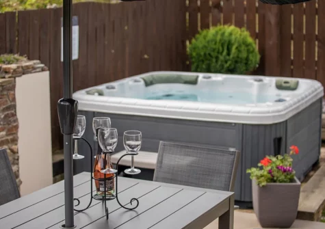 The courtyard, barbecue, alfresco dining area & hot tub at Duck Egg Cottage, Westward Ho!