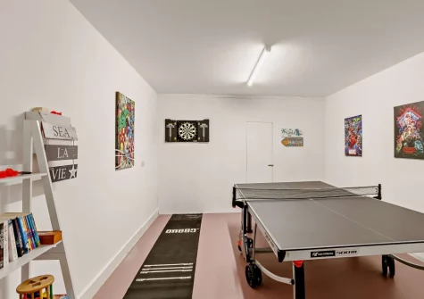 The games room, with table tennis, darts, books & games, at Dune Beachhouse, Westward Ho!