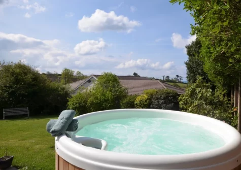The hot tub & enclosed lawned garden at Eddystone View, Wembury