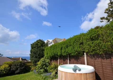 The hot tub & enclosed lawned garden at Eddystone View, Wembury