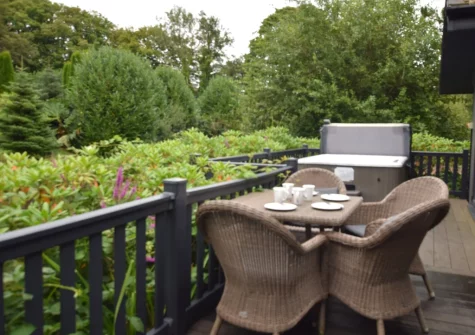 The decked patio, alfresco dining area & hot tub at Exmoor View at Kentisbury Grange, Kentisbury