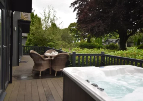 The decked patio, alfresco dining area & hot tub at Exmoor View at Kentisbury Grange, Kentisbury