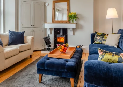 Failte View, Brixham is a stylish two-bedroom apartment perched above this historic fishing port, featuring harbour views from the lounge and master bedroom, a cosy wood burner, and contemporary interiors just steps from the waterfront.