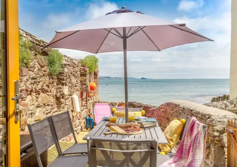 The decked patio, alfresco dining & outdoor sitting area at Fairwinds, Cawsand