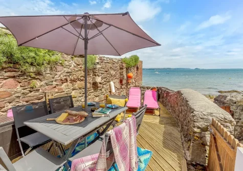 The decked patio, alfresco dining & outdoor sitting area at Fairwinds, Cawsand