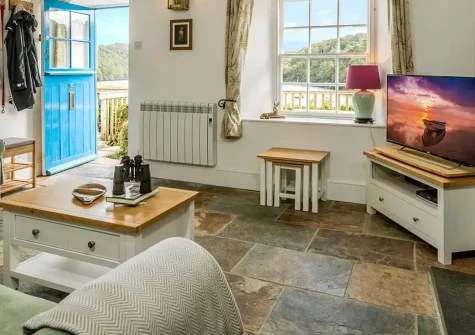 Fal River Cottage, Malpas is a charming riverside retreat with stunning river views and elevated tiered gardens. Enjoy cosy interiors with woodburning stove, perfect for couples & small families seeking riverside charm near the coast.