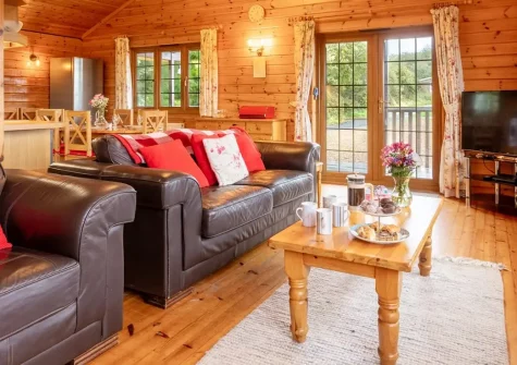 Falcon Lodge 12, Clovelly Lakes is a charming four-bedroom lakeside lodge with private balcony, enclosed gardens, and complimentary family fishing. Perfect for families seeking a tranquil retreat surrounded by woodland and five beautiful lakes.