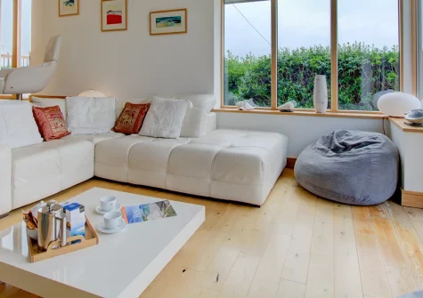 Farmlands, Porthcothan is an impressive single-storey retreat with three bedrooms and sea views. Featuring luxury bathrooms, a suspended wood burner, and panoramic countryside vistas, it's perfect for families seeking a Cornish coastal escape.