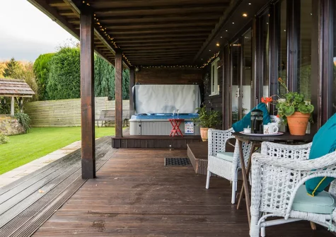 The decked terrace, hot tub, & garden at Felicity Orchard, Holcombe Rogus