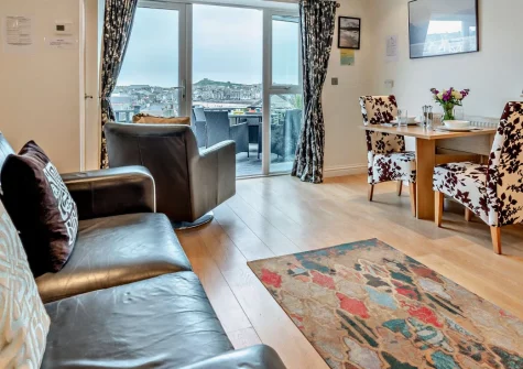 Fernlea Court, St Ives is a stylish one-bedroom apartment with breathtaking bay and harbour views from its terrace, moments from the beaches, galleries and restaurants of this beloved Cornish town, with private parking conveniently located nearby.