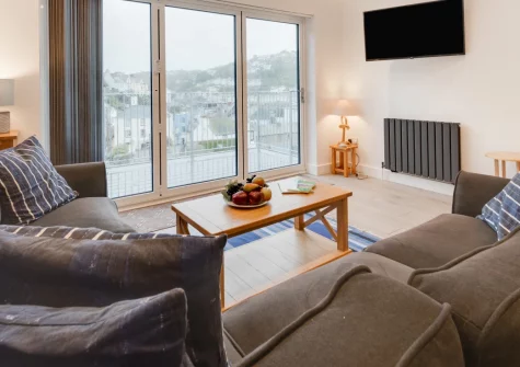 Ferry View, Looe is a contemporary three-storey retreat sleeping six, boasting panoramic views across the town and River Looe from its first-floor living area and balcony, with the South West Coast Path and beaches moments from your door.
