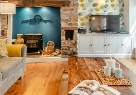 Ferrymans Cottage, Appledore is a beautifully restored fisherman's cottage metres from the historic quayside, featuring exposed beams, contemporary styling, a master bedroom with balcony, and easy access to coastal paths and sandy beaches.