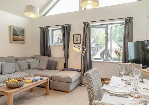 Ferryman's Wharf, Fowey is a stylish riverside apartment with panoramic estuary views. Perfect for couples and small families, enjoy an open-plan layout, contemporary kitchen, and direct access to Fowey's charming harbour and nearby beaches.