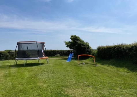The shared garden with trampoline & football goals, perfect for children, at Firebeacon, Firebeacon Farm, Edistone
