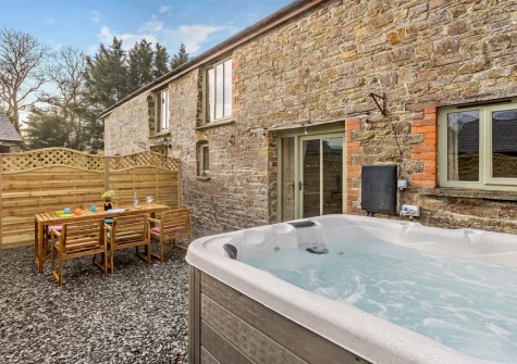 The enclosed courtyard, alfresco dining area & hot tub at Fisherman's Rest at Blagdon Farm, Ashwater