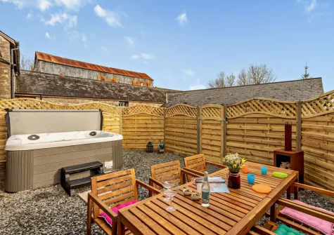 The enclosed courtyard, alfresco dining area & hot tub at Fisherman's Rest at Blagdon Farm, Ashwater