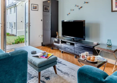 Fistral Gaze, Newquay is a contemporary two-bedroom apartment with breathtaking views across Fistral Bay, featuring stylish coastal interiors, a shared garden terrace, and with easy access to one of the UK's most famous surfing beaches.