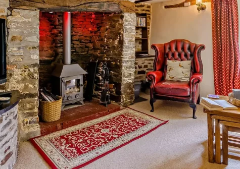 Ford Mill Dairy, Ashmansworthy is a charming 2-bedroom barn conversion on working farmland near the Devon/Cornwall border. Enjoy countryside walks, an on-site fishing lake, and cosy wood burner interiors perfect for peaceful family retreats.