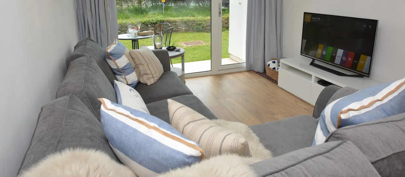 Fourteen Mawgan Porth, Mawgan Porth is an elegant ground-floor apartment with countryside views, private patio, and access to shared pool and tennis courts. Just minutes from golden sands and village amenities for an unforgettable Cornish break.
