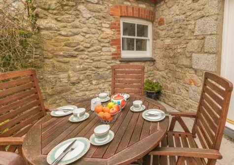 The patio & alfresco dining area at Foxglove Cottage at Gadles Farm, Laity Moor