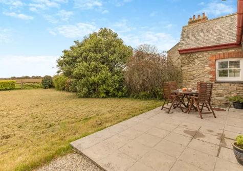 The patio, alfresco dining area & large lawned enclosed garden at Foxglove Cottage at Gadles Farm, Laity Moor