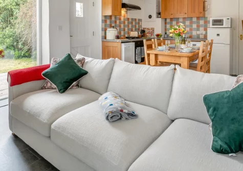 Foxglove Cottage at Gadles Farm, Laity Moor is a beautifully converted barn set on peaceful farmland near Ponsanooth, featuring open-plan living spaces, enclosed garden with rolling countryside views, and easy access to both Cornish coasts.
