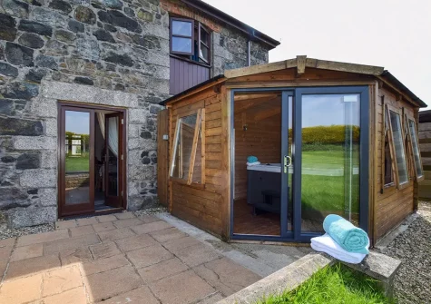 The patio & hot tub at Foxgloves, Higher Trenower Farm, Newtown-in-St-Martin