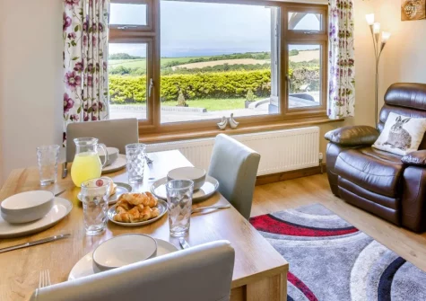 Gallantry Bower, Higher Clovelly is a spacious two-bedroom house retreat boasting sweeping sea views, an indoor heated pool, farm animals to visit, and easy access to North Devon's stunning coastline and Clovelly's famous cobbled streets.