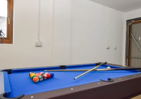A snooker and air hockey table is set up for use in the garage