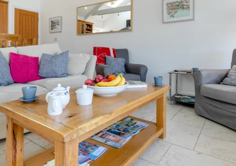 Gartree Cottage, Polruan is a charming seaside cottage with captivating harbour views, stylish coastal interiors, and front and rear gardens, positioned just yards from the water's edge in this peaceful former fishing village across from Fowey.