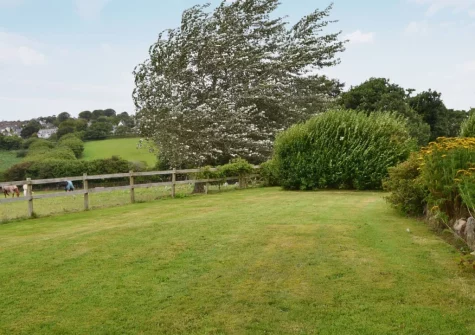 The enclosed lawned garden at Gewans Farm Cottage, Tregorrick