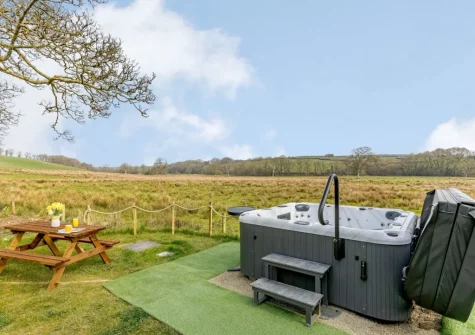 The hot tub, alfresco dining area & fa reaching countryside views at Gidcott Cottage, Gidcott